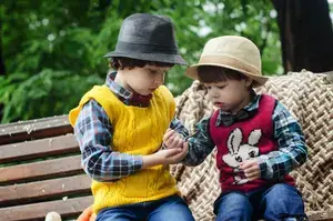 Kids sitting on a bench sharing sweets